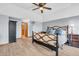 Bright main bedroom with a ceiling fan, wood flooring and a wrought iron king-size bed at 7304 E Stop 11 Rd, Indianapolis, IN 46259