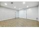 Finished basement with white brick wall, laminate flooring, and sliding glass doors at 7468 Countrybrook Dr, Indianapolis, IN 46260