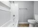 Clean bathroom featuring a toilet, tub/shower combo, and towel rack at 7468 Countrybrook Dr, Indianapolis, IN 46260