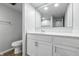 Clean bathroom featuring a toilet, vanity and large mirror at 7468 Countrybrook Dr, Indianapolis, IN 46260