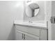 Clean bathroom vanity featuring a round mirror and white cabinets at 7468 Countrybrook Dr, Indianapolis, IN 46260