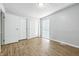 Bright bedroom with hardwood floors, two closets, and natural light at 7468 Countrybrook Dr, Indianapolis, IN 46260