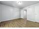 Neutral bedroom with wood flooring, a ceiling light, and an open doorway at 7468 Countrybrook Dr, Indianapolis, IN 46260
