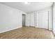 Simple bedroom featuring wood flooring, a window, and dual closets at 7468 Countrybrook Dr, Indianapolis, IN 46260