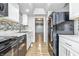 Kitchen with stainless steel appliances, white cabinets, and attractive backsplash at 7468 Countrybrook Dr, Indianapolis, IN 46260