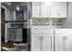 Kitchen features stainless steel fridge, white cabinets, and stylish backsplash at 7468 Countrybrook Dr, Indianapolis, IN 46260