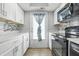 Bright kitchen boasts white cabinets, granite countertops, and stainless steel appliances at 7468 Countrybrook Dr, Indianapolis, IN 46260