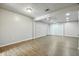 Spacious living room with wood flooring, a white brick accent wall, and recessed lighting at 7468 Countrybrook Dr, Indianapolis, IN 46260