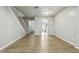 Spacious living room with hardwood floors, neutral paint, and stairway to upper level at 7468 Countrybrook Dr, Indianapolis, IN 46260