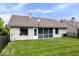 Spacious backyard with well-maintained lawn, black fence, and screened-in porch at 8213 Thoroughbred Run, Indianapolis, IN 46256