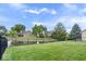 Expansive backyard showcasing a pond, mature trees, and a well-kept lawn at 8213 Thoroughbred Run, Indianapolis, IN 46256