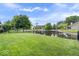 Lush backyard featuring a pond, mature trees, and a sprawling green lawn at 8213 Thoroughbred Run, Indianapolis, IN 46256