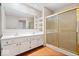 Bathroom featuring a dual sink vanity with a mirror, and a glass shower at 8213 Thoroughbred Run, Indianapolis, IN 46256