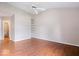 Spacious bedroom featuring hardwood floors, a ceiling fan, and built-in shelving at 8213 Thoroughbred Run, Indianapolis, IN 46256