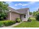 Charming exterior featuring brick accents, lush landscaping, and a well-manicured lawn at 8213 Thoroughbred Run, Indianapolis, IN 46256