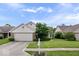 Traditional single-Gathering home featuring a large front yard with healthy green grass and mature landscaping at 8213 Thoroughbred Run, Indianapolis, IN 46256