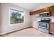 Well-lit kitchen features wood cabinets and stainless steel appliances with a large window providing lots of light at 8213 Thoroughbred Run, Indianapolis, IN 46256