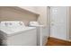 Functional laundry room featuring modern washer and dryer appliances and a door at 8213 Thoroughbred Run, Indianapolis, IN 46256