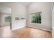 Open concept living room showcasing hardwood floors, a large window and a view into the kitchen at 8213 Thoroughbred Run, Indianapolis, IN 46256
