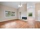 Spacious living room with fireplace, wood floors, recessed lighting, and large windows for natural light at 8213 Thoroughbred Run, Indianapolis, IN 46256