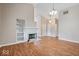 Open-concept living area with hardwood flooring, a fireplace, and built-in shelving for added storage at 8213 Thoroughbred Run, Indianapolis, IN 46256
