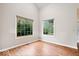Bright living room with hardwood floors and large windows offering a view of the outdoors at 8213 Thoroughbred Run, Indianapolis, IN 46256