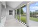 Inviting screened porch offering serene views of the lush backyard and pond at 8213 Thoroughbred Run, Indianapolis, IN 46256