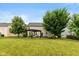 A large, green backyard with a pergola-covered patio and mature trees, perfect for outdoor living at 8336 Bent Oak Dr, Indianapolis, IN 46236