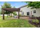Beautiful backyard with a pergola, stone patio, and outdoor seating area at 8336 Bent Oak Dr, Indianapolis, IN 46236