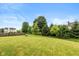 Spacious backyard with mature trees and a large grassy area for outdoor activities at 8336 Bent Oak Dr, Indianapolis, IN 46236