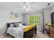 Comfortable bedroom featuring a plush bed, bright window, and charming decor at 8336 Bent Oak Dr, Indianapolis, IN 46236