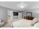 Comfortable bedroom with mounted TV, dresser with mirror, and neutral color palette at 8336 Bent Oak Dr, Indianapolis, IN 46236