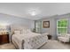 Cozy bedroom with a decorative ceiling light fixture and ample natural light at 8336 Bent Oak Dr, Indianapolis, IN 46236