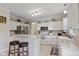 Well-lit kitchen with white cabinets, breakfast bar, and modern stainless steel appliances at 8336 Bent Oak Dr, Indianapolis, IN 46236