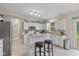 Bright kitchen with white cabinets, breakfast bar, and stainless steel appliances at 8336 Bent Oak Dr, Indianapolis, IN 46236