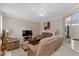 Cozy living room features plush seating, ceiling fan, and open doorway to the foyer at 8336 Bent Oak Dr, Indianapolis, IN 46236