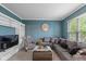 Comfortable living room with a plush gray sectional sofa and ample natural light at 8336 Bent Oak Dr, Indianapolis, IN 46236