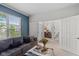 Cozy living room featuring a comfortable gray sofa and a glimpse into the dining area at 8336 Bent Oak Dr, Indianapolis, IN 46236