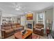 Spacious living room boasts fireplace, plush furniture, and seamless flow into kitchen at 8336 Bent Oak Dr, Indianapolis, IN 46236