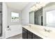 Bathroom with a tub, double sink vanity, and a separate shower room for ultimate convenience at 8864 Rowling Way, Indianapolis, IN 46239