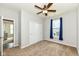 Bedroom featuring neutral walls, carpet, ceiling fan, window, and closet at 8864 Rowling Way, Indianapolis, IN 46239