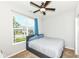 Bedroom features a ceiling fan, window with a view, and carpeted floors at 8864 Rowling Way, Indianapolis, IN 46239
