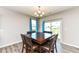Cozy dining area with stylish chandelier and sliding door access to the backyard at 8864 Rowling Way, Indianapolis, IN 46239