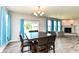 Bright dining room features a wood table, six chairs, wood floors, and a stone fireplace at 8864 Rowling Way, Indianapolis, IN 46239