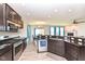 Modern kitchen with stainless steel appliances and granite countertops, open to the living space at 8864 Rowling Way, Indianapolis, IN 46239