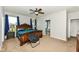 Comfortable main bedroom with a ceiling fan, plush carpet, a wood bed frame, and tasteful decor at 8864 Rowling Way, Indianapolis, IN 46239