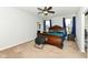 Comfortable main bedroom with a ceiling fan, plush carpet, a wood bed frame, and tasteful decor at 8864 Rowling Way, Indianapolis, IN 46239