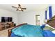 Comfortable main bedroom with a TV, ceiling fan, and an ensuite bathroom with a tub at 8864 Rowling Way, Indianapolis, IN 46239