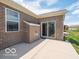 An outdoor back patio featuring a sliding glass door and a well-maintained lawn at 8866 Twain Ln, Indianapolis, IN 46239