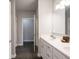 Well-lit bathroom featuring double sinks, modern lighting, and white cabinets at 8866 Twain Ln, Indianapolis, IN 46239